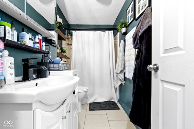 bathroom featuring tile patterned floors, a shower with curtain, vanity, and toilet