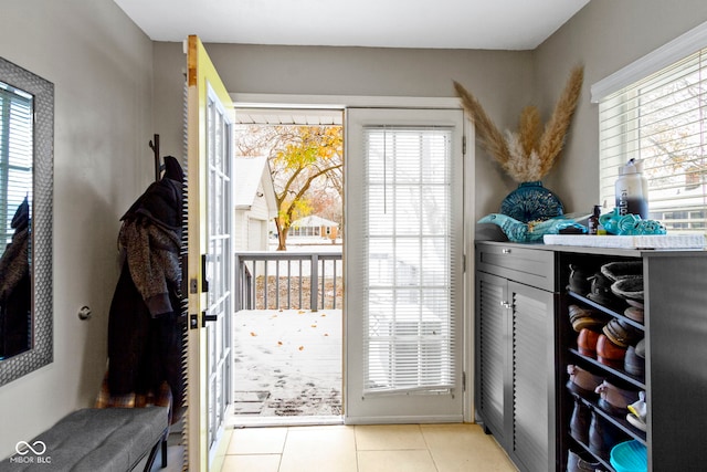 doorway featuring a healthy amount of sunlight and light tile patterned floors