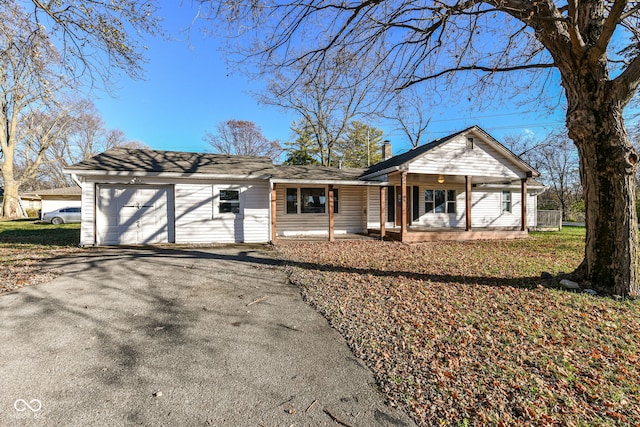 ranch-style house with a porch and a garage