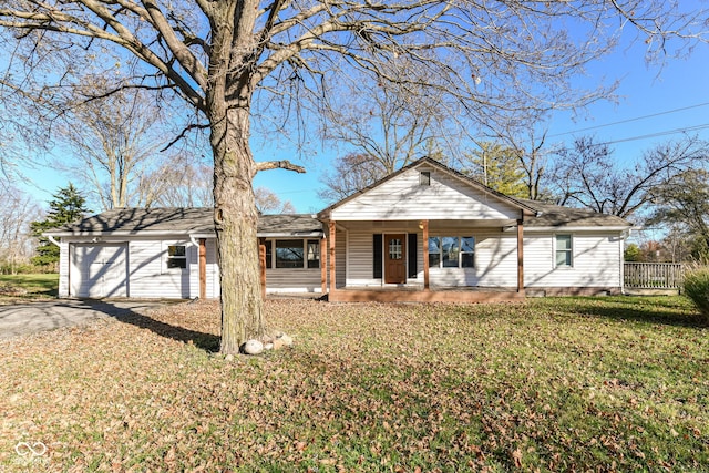 ranch-style home featuring covered porch, a garage, and a front lawn