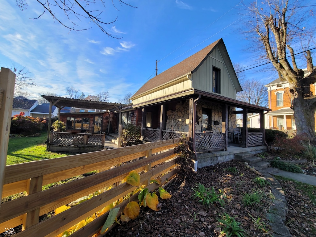 back of property with a porch and a pergola