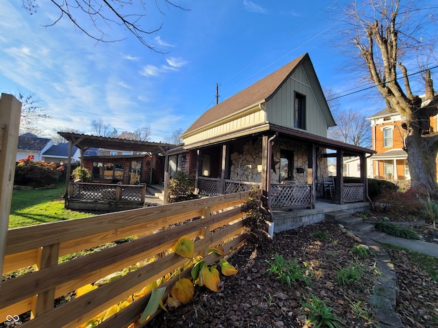 back of property with a porch and a pergola