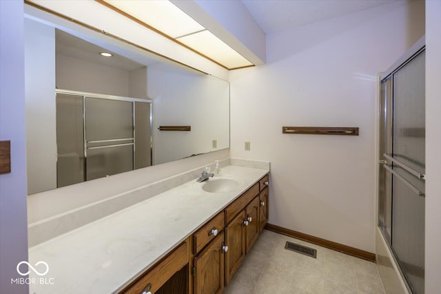 bathroom with shower / bath combination with glass door, tile patterned floors, and vanity