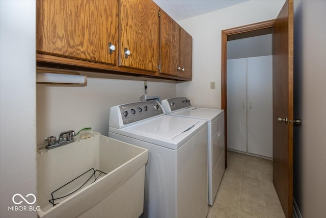 laundry area with cabinets, sink, and washing machine and clothes dryer