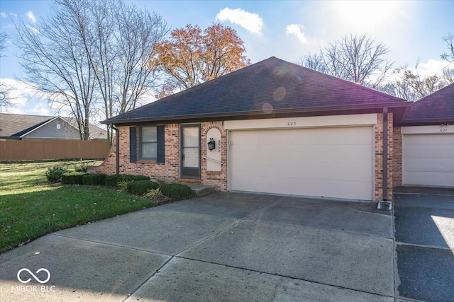 ranch-style home with a garage and a front yard