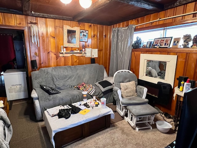 interior space with beamed ceiling, wooden walls, carpet floors, and wooden ceiling