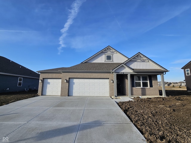 view of front of house with driveway, a garage, roof with shingles, board and batten siding, and brick siding