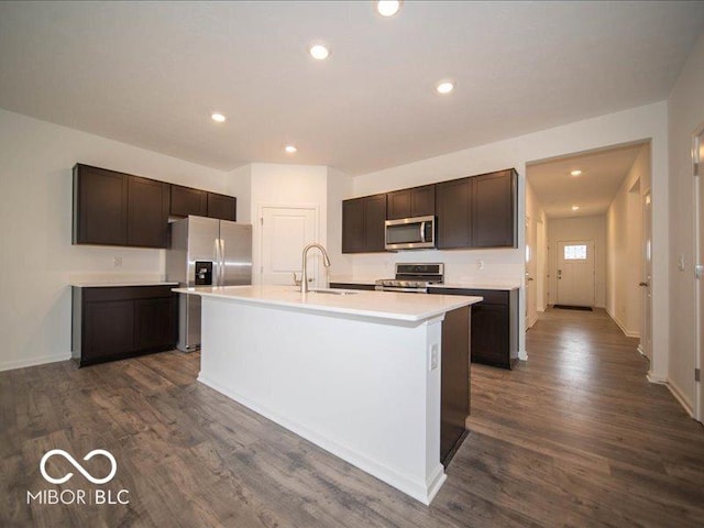 6322 Granby Dr, Whitestown, IN 46075 - kitchen featuring stainless steel appliances, dark brown cabinetry, light countertops, a kitchen island with sink, and recessed lighting