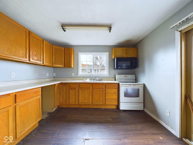 31 S Superior St, Orestes, IN 46063 - kitchen featuring white range with electric cooktop, black microwave, dark wood finished floors, brown cabinets, and light countertops