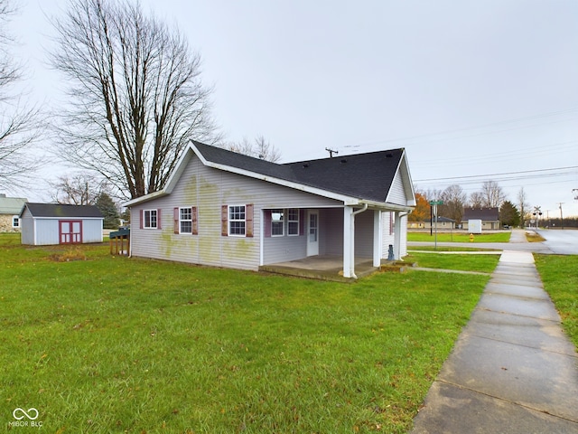 view of side of home with an outdoor structure and a lawn