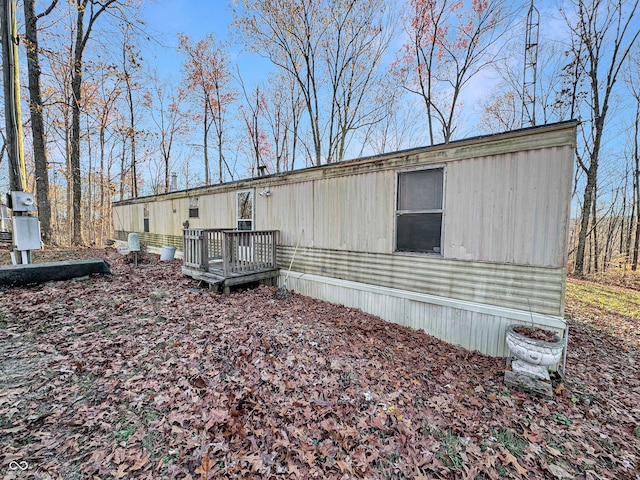 view of home's exterior with a wooden deck