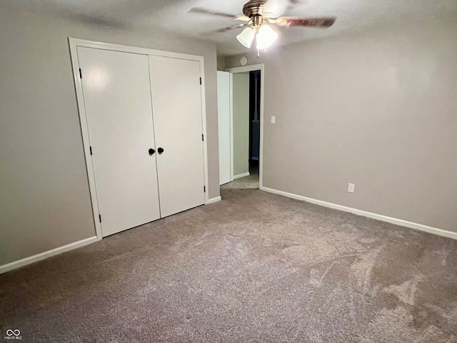 unfurnished bedroom featuring carpet floors, a closet, and ceiling fan