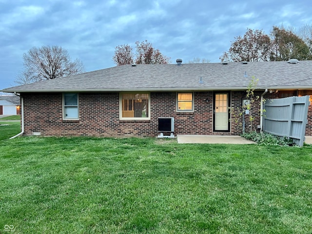 back of house with a lawn and a patio area