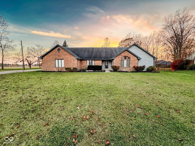 ranch-style house featuring a lawn