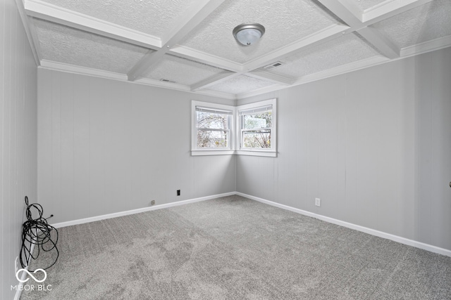 carpeted empty room with beamed ceiling, ornamental molding, and coffered ceiling