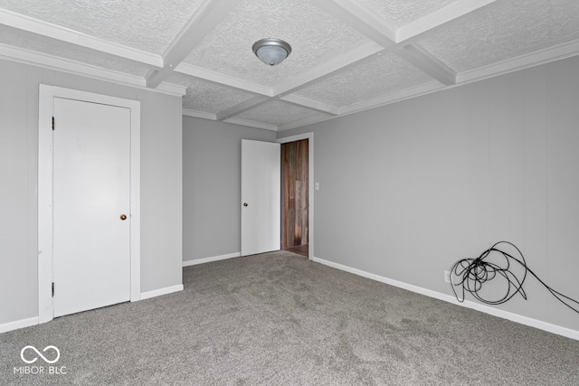 unfurnished bedroom with beam ceiling, carpet floors, a closet, and coffered ceiling