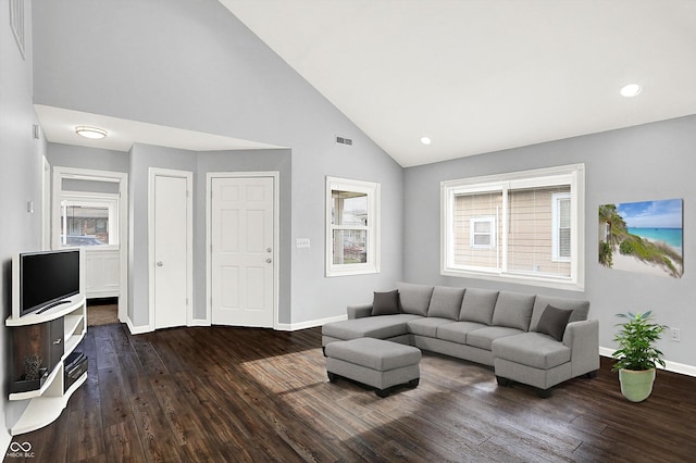 living room with dark hardwood / wood-style flooring and high vaulted ceiling