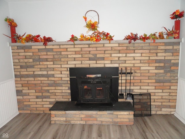 details featuring wood-type flooring and a wood stove