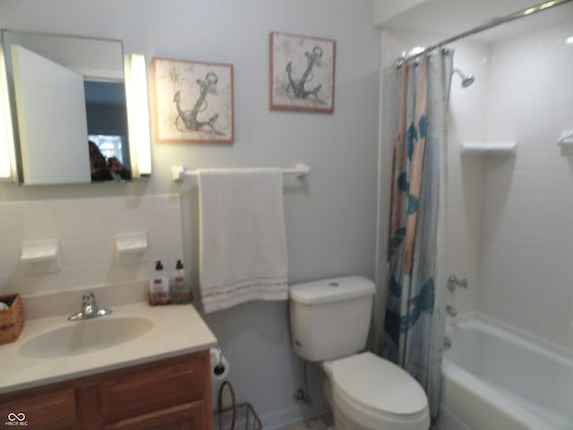 full bathroom with vanity, toilet, backsplash, and shower / tub combo