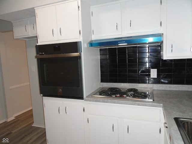 kitchen with white cabinets, decorative backsplash, dark wood-type flooring, and appliances with stainless steel finishes