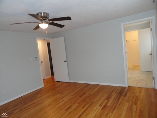 unfurnished room with light hardwood / wood-style floors and ceiling fan