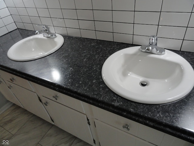 bathroom with vanity, backsplash, and tile walls