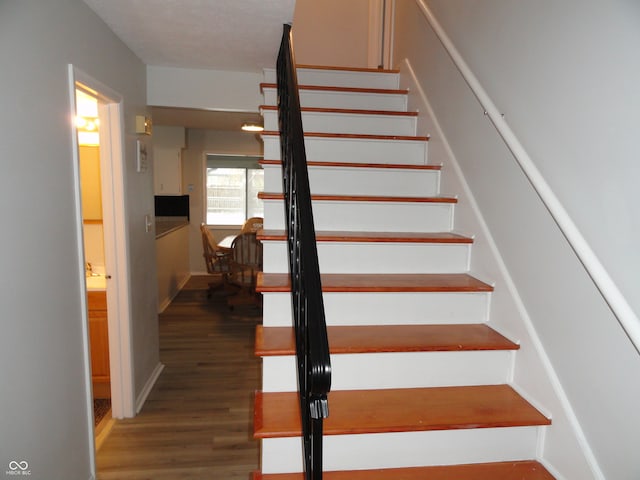 stairway with hardwood / wood-style flooring