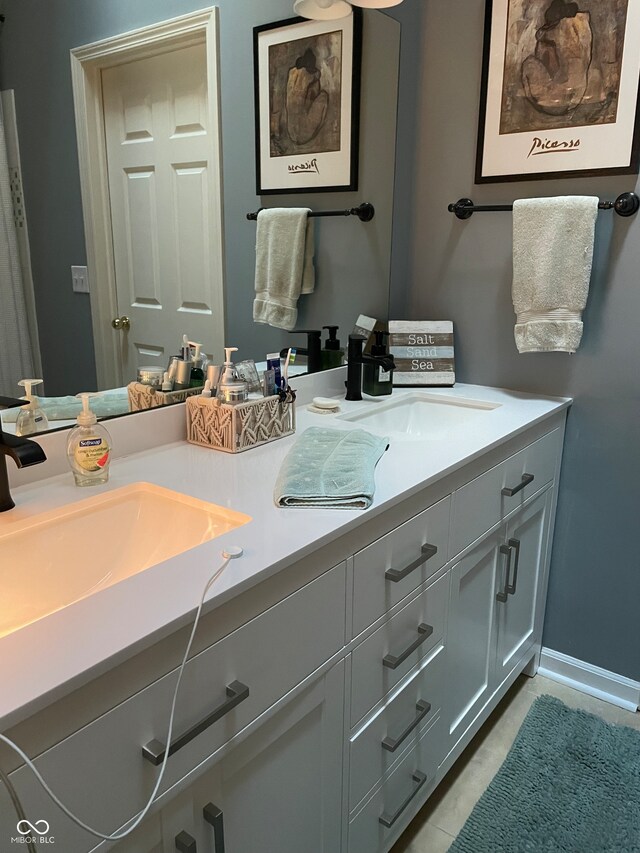 bathroom with tile patterned floors and vanity