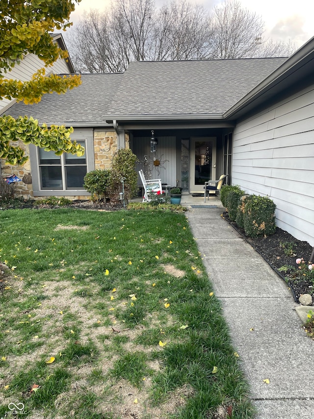 doorway to property with a yard