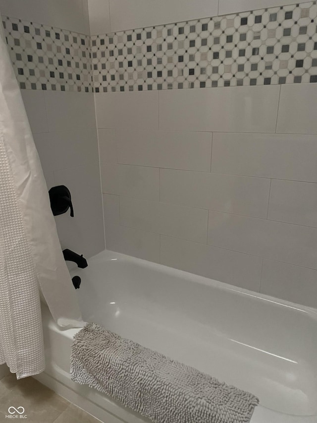 bathroom with shower / bath combo and tile patterned floors