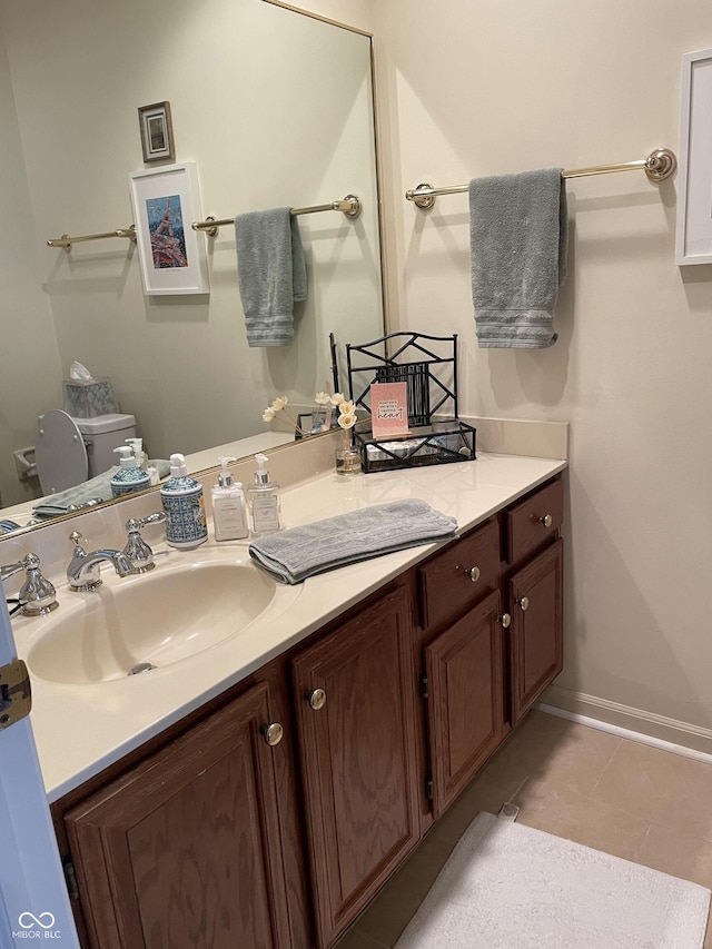 bathroom featuring tile patterned floors, vanity, and toilet