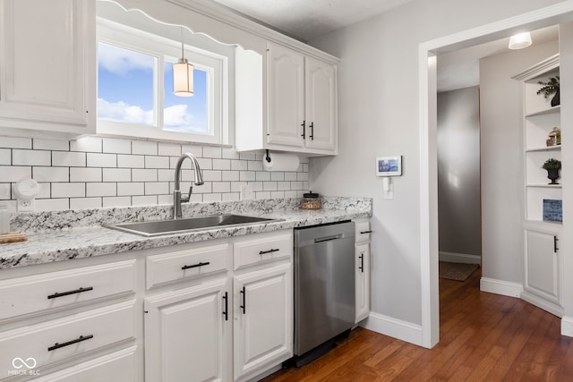 kitchen with white cabinetry, sink, dark wood-type flooring, tasteful backsplash, and stainless steel dishwasher