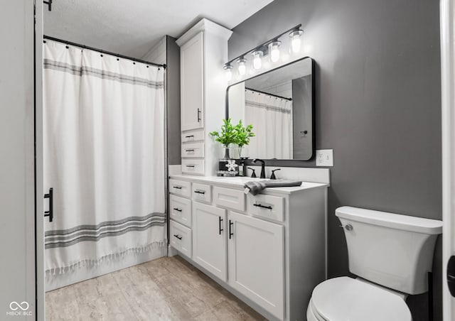 full bathroom with vanity, shower / bath combination with curtain, toilet, a textured ceiling, and wood-type flooring