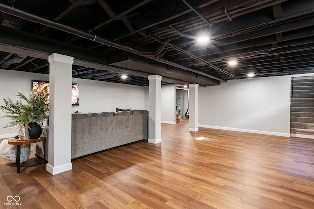 basement with hardwood / wood-style flooring