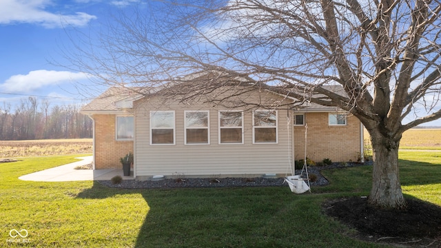 view of home's exterior with a lawn