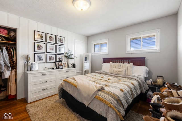 bedroom with dark wood-type flooring and a textured ceiling