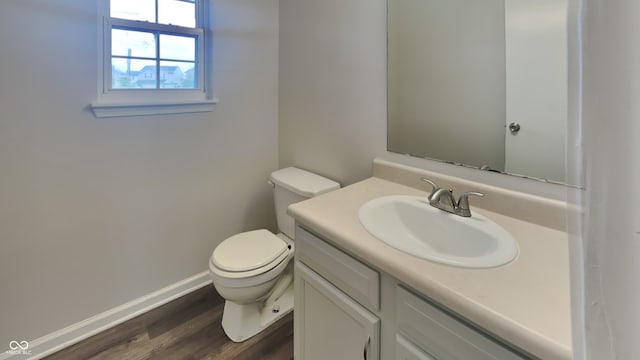 bathroom featuring vanity, hardwood / wood-style flooring, and toilet