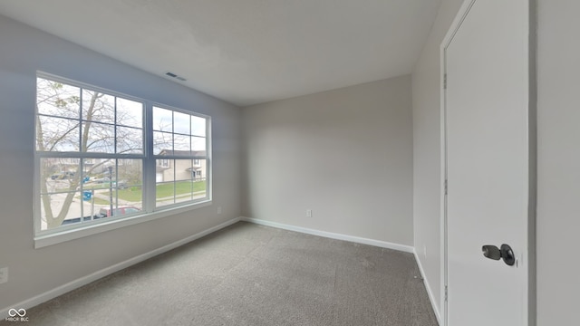 unfurnished room featuring carpet