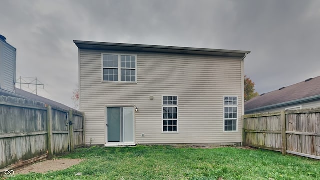 rear view of house with a yard