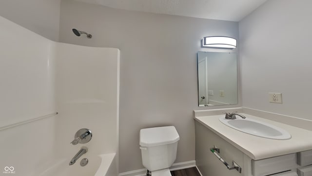 full bathroom with shower / washtub combination, vanity, hardwood / wood-style floors, and toilet