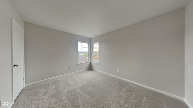 unfurnished room with light colored carpet