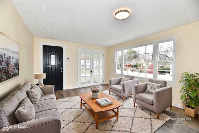 living room with a textured ceiling and light hardwood / wood-style flooring