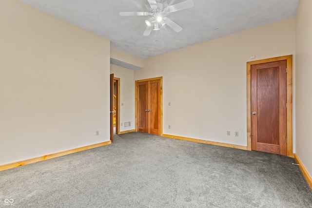 carpeted spare room with ceiling fan