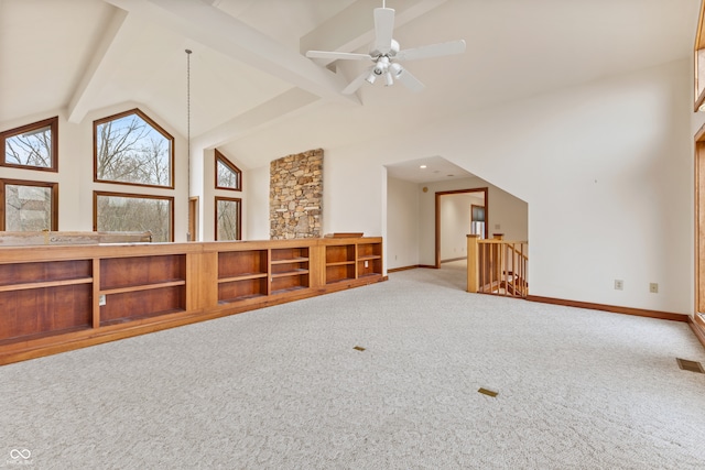 interior space featuring beam ceiling, ceiling fan, carpet, and high vaulted ceiling