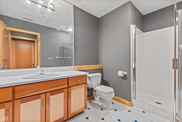 bathroom featuring vanity, toilet, and an enclosed shower