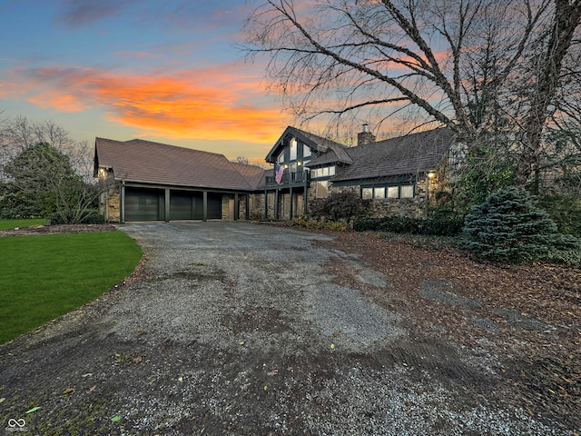 view of front of home featuring a lawn, a garage, and a balcony