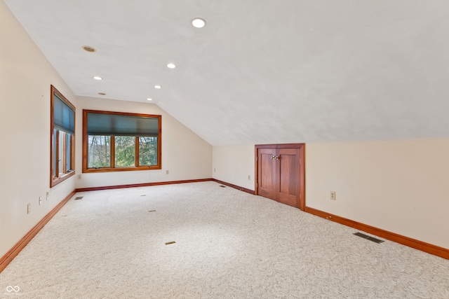 bonus room featuring light carpet and lofted ceiling