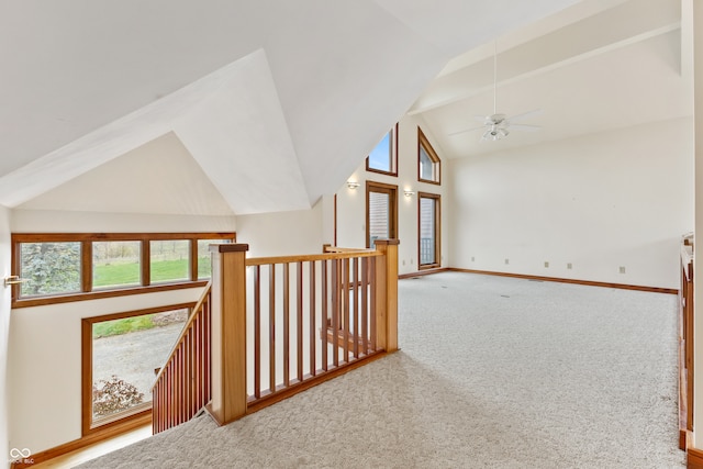 corridor with carpet flooring and vaulted ceiling