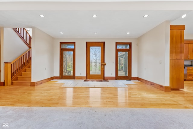 foyer entrance with light hardwood / wood-style flooring