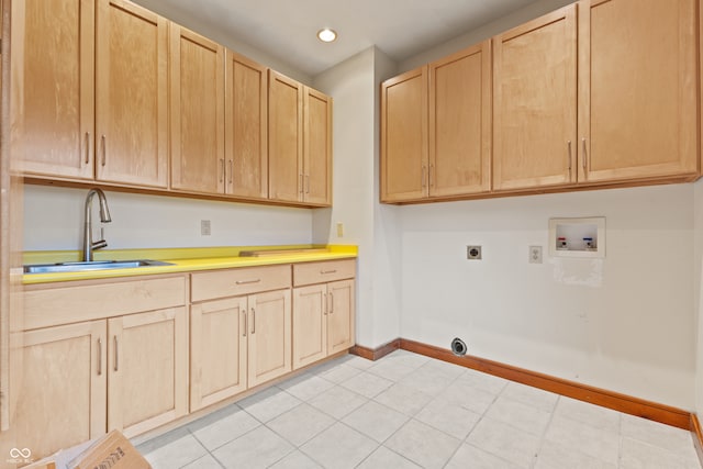 laundry room featuring electric dryer hookup, cabinets, sink, washer hookup, and light tile patterned flooring